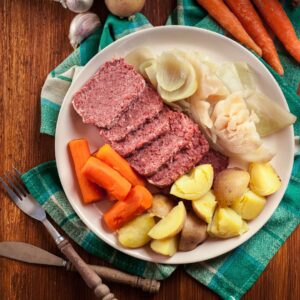 A plate of corned beef and vegetables