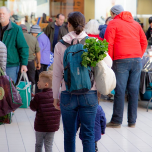 People shopping at an indoor farmers market