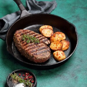 Steak and potatoes in a cast iron skillet