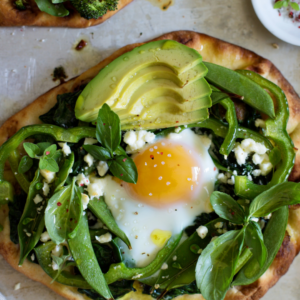 spinach breakfast pizza with egg and sausage
