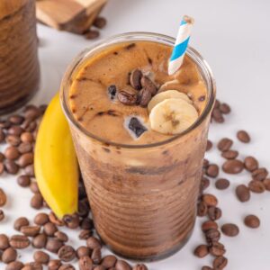 Coffee smoothie in a glass with a straw