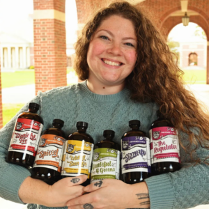 A person holding bottles of apple cider vinegar tonics
