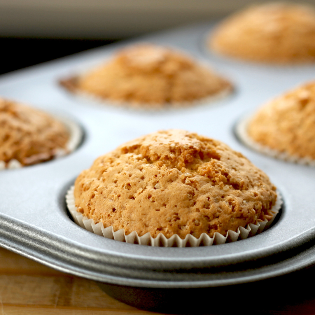 Muffin pan with fresh baked carrot muffins