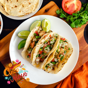 Chicken tacos topped with pico de Gallo on a plate