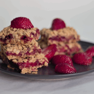 Strawberry oatmeal bars cut and on a plate to serve