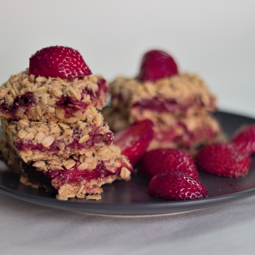 Strawberry oatmeal bars cut and on a plate to serve