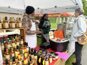Vendors at the Saratoga Farmers' Market selling sauces for grilling