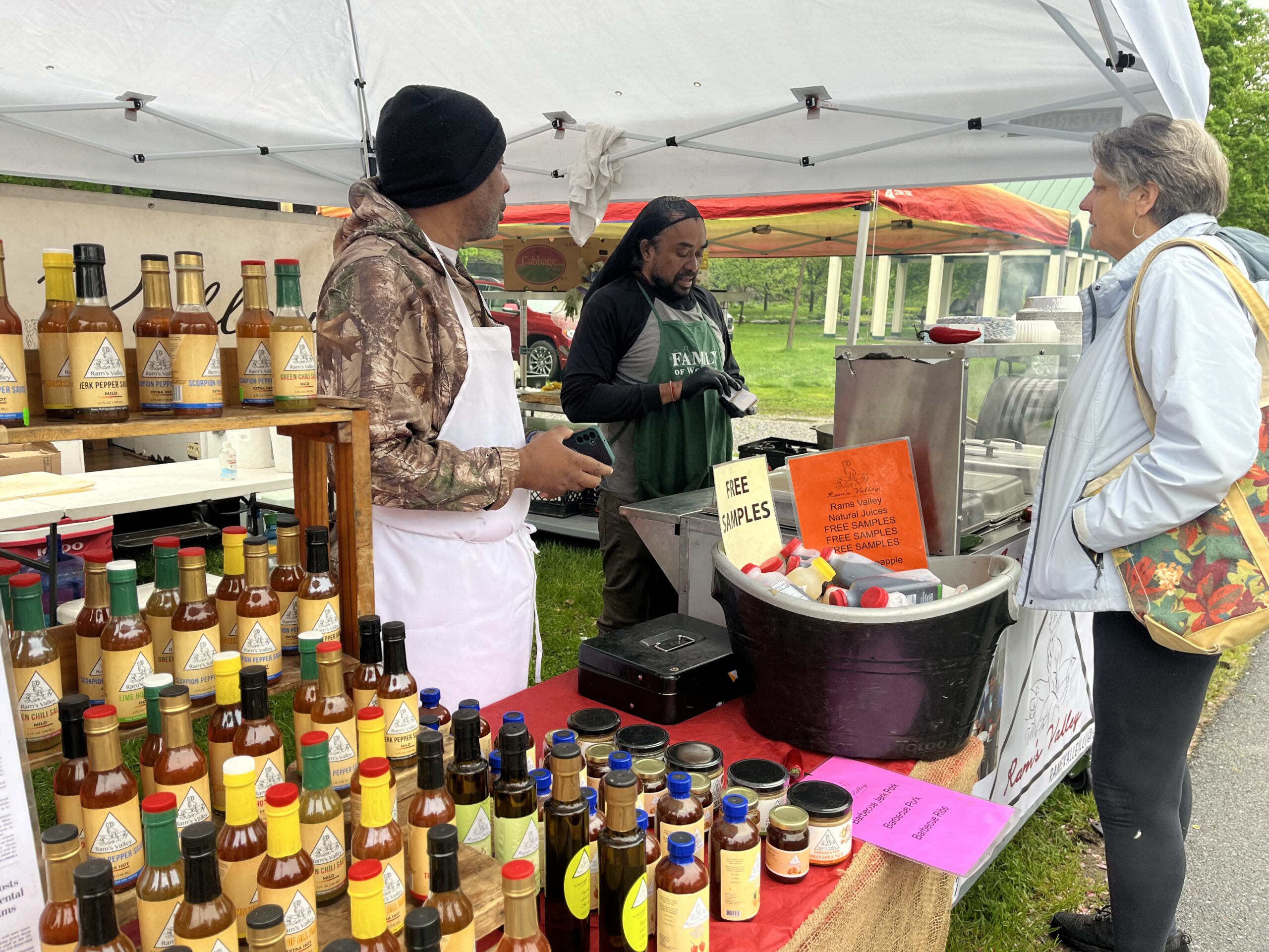Vendors at the Saratoga Farmers' Market selling sauces for grilling