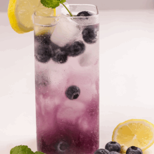 A mocktail made with blueberry, lemon, basil and lavender ready to serve.