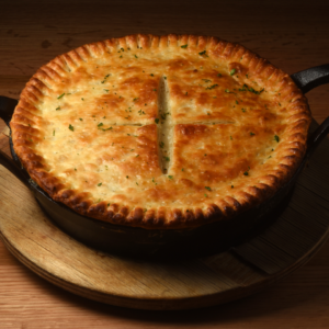 A baked pot pie in a cast iron skillet